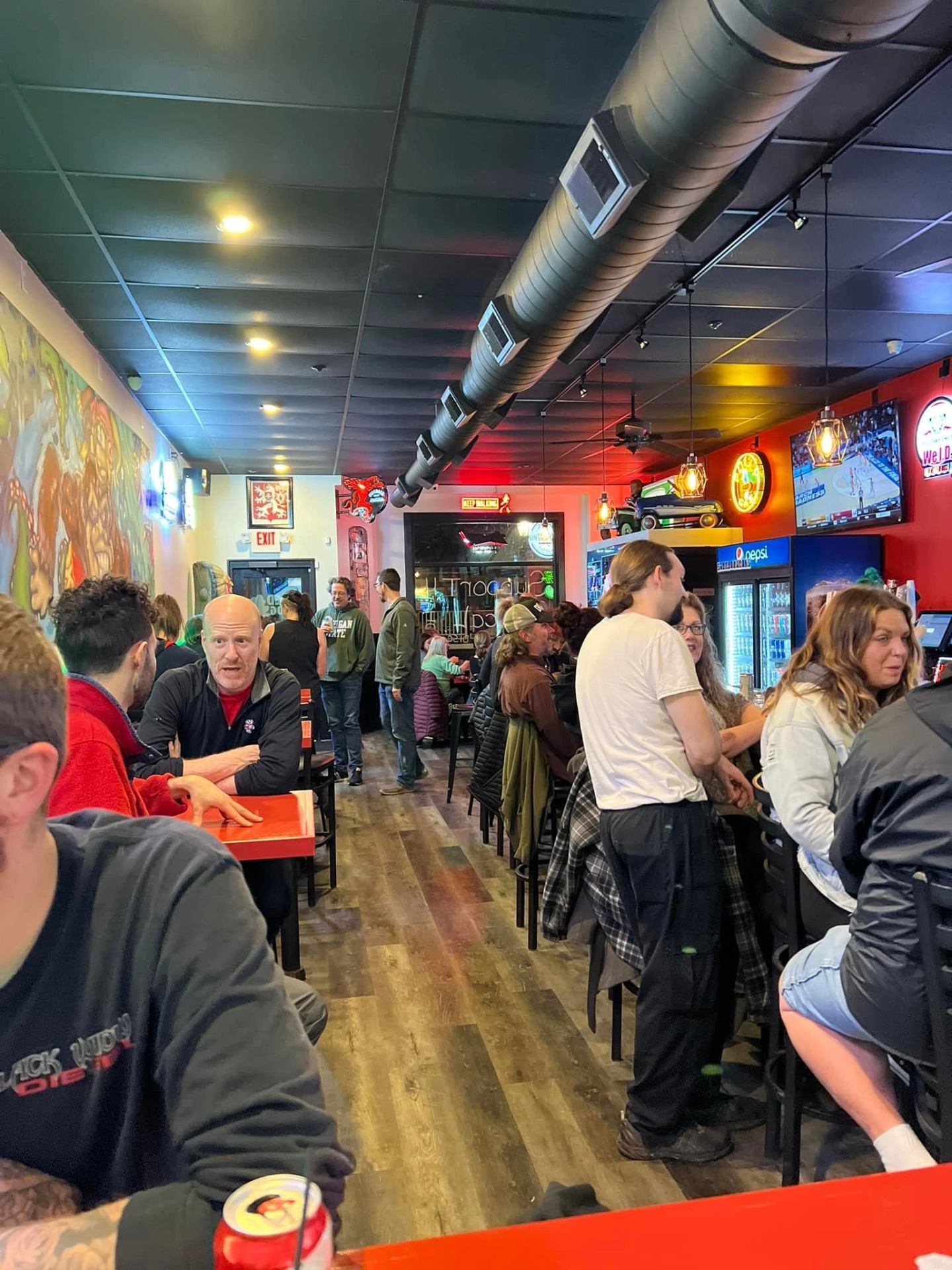 Inside The Red Frog with patrons at the bar